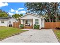 Cute cottage with a gravel driveway and fenced yard at 6297 29Th N St, St Petersburg, FL 33702