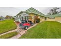 Golf cart parked near building entrance at 102 Cambridge Trl # 225, Sun City Center, FL 33573