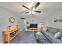 Living room with sofa, TV, and coffee table at 102 Cambridge Trl # 225, Sun City Center, FL 33573
