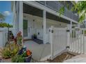 Inviting front entrance with a white picket fence and landscaping at 109 Peterson Ln, Palm Harbor, FL 34683