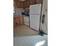 Galley kitchen with ample cabinetry and appliances at 1463 Bobolink St, Zephyrhills, FL 33540