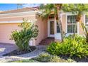 Front entrance with a brick walkway, lush landscaping, and a double-door entry at 1613 Sand Key Estates Ct, Clearwater, FL 33767