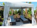 Relaxing cabana with two lounge chairs and a small table at 18302 Wheathouse Pl, Lakewood Ranch, FL 34211