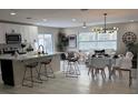 Open concept kitchen with white shaker cabinets and marble countertops at 2885 St John Dr, Clearwater, FL 33759