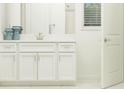 Elegant bathroom with white cabinets, quartz countertops, and tile shower at 31537 Cardinal Yard Dr, San Antonio, FL 33576