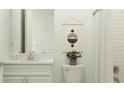 Clean bathroom with white vanity, tile shower, and neutral decor at 31537 Cardinal Yard Dr, San Antonio, FL 33576