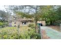 Tan brick ranch home with driveway and yard at 6405 Riverbend Cir, Tampa, FL 33610