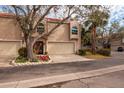 Tan two-story townhome with attached garage and lush landscaping at 661 Segovia Ne Ct, St Petersburg, FL 33703