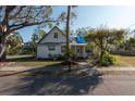Charming one-story home with a covered porch and mature landscaping at 7408 S Elliott St, Tampa, FL 33616