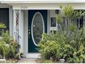 Inviting front door entry with lush landscaping at 9524 Treasure Ne Ln, St Petersburg, FL 33702