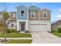 Two-story house with blue and beige siding, white garage door, and landscaping at 12804 Bent Twig Dr, Riverview, FL 33579