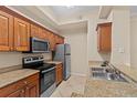Modern kitchen with wood cabinets and granite countertops at 17108 Carrington Park Dr # 710, Tampa, FL 33647