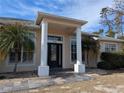 Home entrance with columns and stone flooring at 2365 Ardenwood Dr, Spring Hill, FL 34609