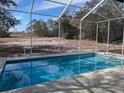 Relaxing screened-in pool with open backyard view at 2365 Ardenwood Dr, Spring Hill, FL 34609