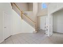 Bright and spacious entryway with tiled floors and staircase at 3533 Juneberry Drive, Wesley Chapel, FL 33543