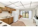 Efficient kitchen with white appliances and wood cabinets at 4920 Locust Ne St # 116, St Petersburg, FL 33703
