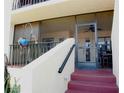 Condo entrance with stairs and screened porch at 6472 Seagull Dr # 303, Bradenton, FL 34210