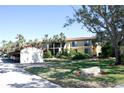 Condo building with parking and mature trees at 6472 Seagull Dr # 303, Bradenton, FL 34210