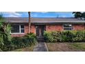 Front view of a brick house with a walkway and landscaping at 6773 14Th N Ave, St Petersburg, FL 33710