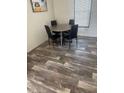 Small dining area with four chairs and wood-look floors at 7337 Desant Ln, Port Charlotte, FL 33981