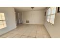 Bright living room with tile floors and large window at 9116 Chantilly Ln, Port Richey, FL 34668