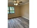 Bright bedroom with ceiling fan and wood-look flooring at 9760 Lake Seminole E Dr, Largo, FL 33773
