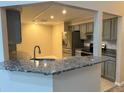Modern kitchen with stainless steel appliances and granite countertops at 9760 Lake Seminole E Dr, Largo, FL 33773