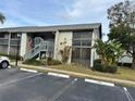 Exterior of condo building with parking and landscaping at 11201 122Nd Ave # 204, Largo, FL 33778