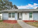 Newly painted exterior with a modern front door and walkway at 2058 Sheffield Ct, Oldsmar, FL 34677