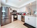 Modern kitchen with stainless steel appliances and white shaker cabinets at 2058 Sheffield Ct, Oldsmar, FL 34677