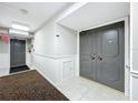Building hallway with carpet, a door, and fire alarm at 220 Belleview Blvd # 609, Belleair, FL 33756