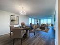 Open concept living and dining area with hardwood floors and city views at 220 Belleview Blvd # 609, Belleair, FL 33756