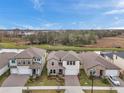 Three-story homes in a community with a lake view at 22294 Storybook Cabin Way, Land O Lakes, FL 34637