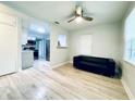 Light and airy living room with hardwood floors and a view of the kitchen at 2314 Auburn S St, St Petersburg, FL 33712