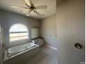 Bathroom features a large garden tub, vanity, and tile flooring at 3040 Sheppards Crook Ct, Holiday, FL 34691