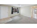 Empty living room with carpet, tiled entryway, and door at 313 10Th N Ave, Safety Harbor, FL 34695