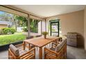 Outdoor screened patio with dining furniture and grill at 4347 Great Lakes N Dr, Clearwater, FL 33762
