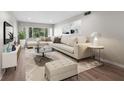 Bright living room featuring a sectional sofa and large windows at 4550 Overlook Ne Dr # 258, St Petersburg, FL 33703