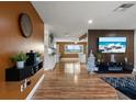 Open living area with L-shaped sofa and wood-look floors at 5135 River Point Ct, New Port Richey, FL 34653