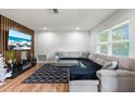 Spacious living room featuring an L-shaped sectional sofa at 5135 River Point Ct, New Port Richey, FL 34653