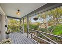 Front porch with view of neighborhood, string lights and hanging planter at 934 21St N Ave, St Petersburg, FL 33704