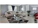 Living room with white sectional sofa and glass coffee table at 10114 Chimney Hill Ct, Tampa, FL 33615