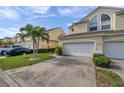 Townhome exterior featuring double garage and manicured landscaping at 1050 Starkey Rd # 2701, Largo, FL 33771