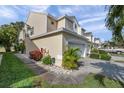 Tan townhome with double garage and side yard landscaping at 1050 Starkey Rd # 2701, Largo, FL 33771