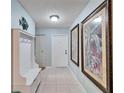 Bright and spacious entryway with built-in bench and decorative wall art at 1111 Harefield Cir # 62, Sun City Center, FL 33573