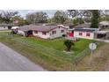 Single-story home with large backyard, detached building, and chain link fence at 12002 Washington St, Seffner, FL 33584