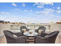 Rooftop patio furniture with city views and granite table at 145 Brightwater Dr # 2, Clearwater, FL 33767