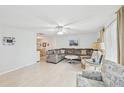 Spacious living room featuring L-shaped sectional sofa and light flooring at 2433 Beacon Dr, Port Charlotte, FL 33952