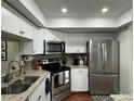 Modern kitchen with stainless steel appliances and granite countertops at 3053 Overlook Pl, Clearwater, FL 33760