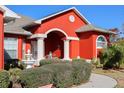 Front entrance with columns, fountain, and manicured landscaping at 3321 Beaver Ave, Spring Hill, FL 34609